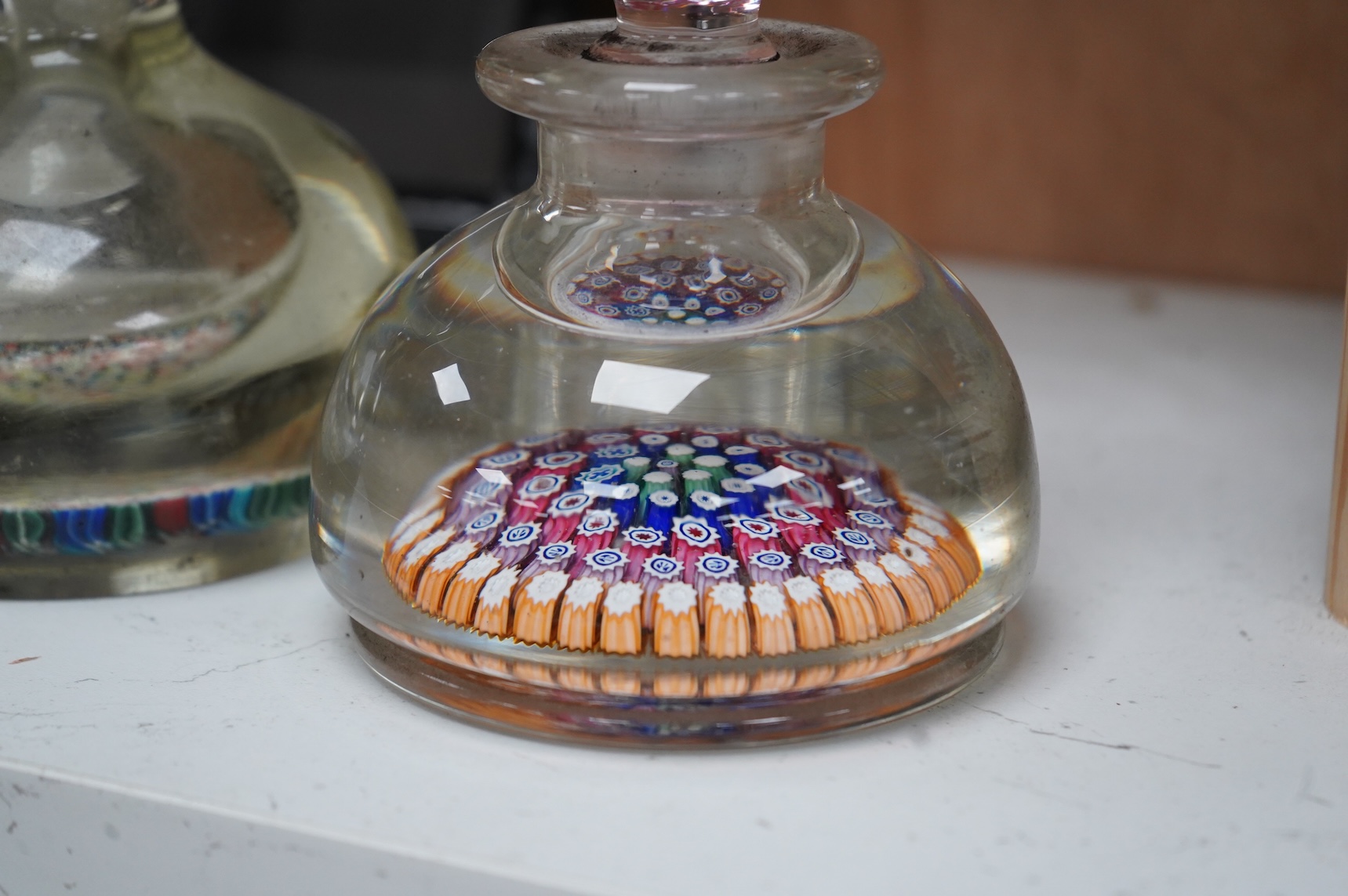 A 19th century millefiori glass inkwell and a similar 20th century inkwell. (2). Largest 16.5cm high